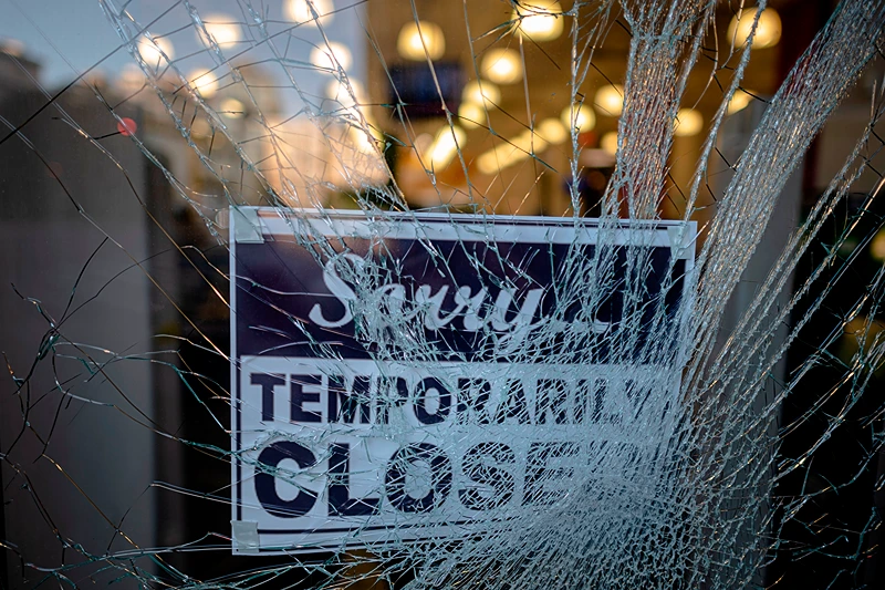 US-POLITICS-RACE-UNREST
A sign reading "sorry temporarily closed" is seen behind a shattered glass of a storefront after a night of protest over the death of African-American man George Floyd in Minneapolis on June 1, 2020 in Lower Manhattan in New York City. - Thousands of National Guard troops patrolled major US cities after five consecutive nights of protests over racism and police brutality that boiled over into arson and looting, sending shock waves through the country. The death Monday of an unarmed black man, George Floyd, at the hands of police in Minneapolis ignited this latest wave of outrage in the US over law enforcement's repeated use of lethal force against African Americans -- this one like others before captured on cellphone video. (Photo by Johannes EISELE / AFP) (Photo by JOHANNES EISELE/AFP via Getty Images)