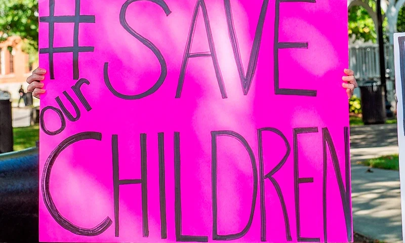 US-CRIME-CHILDREN-PROTEST Demonstrators in Keene, New Hampshire, gather at a "Save the Children Rally" to protest child sex trafficking and pedophilia around the world, on September 19, 2020. - Anti-paedophilia protests are flaring in th US where the QAnon movement started. QAnon is the umbrella term for a sprawling set of internet conspiracy theories that allege that the world is run by a cabal of Satan-worshiping pedophiles who are plotting against US President Donald Trump while operating a global child sex-trafficking ring. (Photo by Joseph Prezioso / AFP) (Photo by JOSEPH PREZIOSO/AFP via Getty Images)