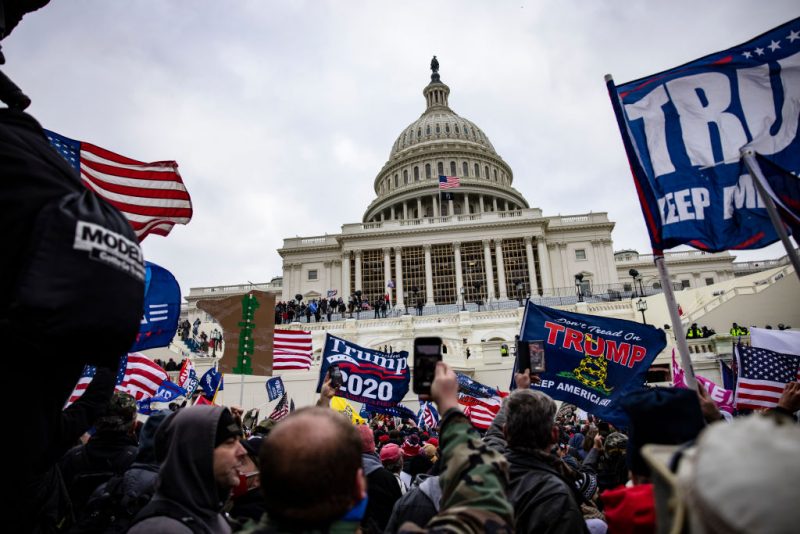 WASHINGTON, DC - JANUARY 06: Pro-Trump supporters storm the U.S. Capitol following a rally with President Donald Trump on January 6, 2021 in Washington, DC. Trump supporters gathered in the nation's capital today to protest the ratification of President-elect Joe Biden's Electoral College victory over President Trump in the 2020 election. (Photo by Samuel Corum/Getty Images)