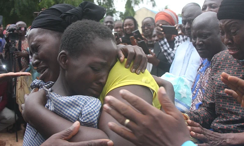 TOPSHOT-NIGERIA-UNREST-KIDNAPPING TOPSHOT - A mother hugs her daughter on July 25, 2021 after she was released together with other 27 students of the Bethel Baptist High School. - Gunmen who seized 121 students at a high school in northwestern Nigeria in early July have released 28 of them, a school official told AFP on Sunday. The attackers stormed Bethel Baptist High School in northwestern Kaduna state on July 5, abducting students who were sleeping in their dorms. (Photo by - / AFP) (Photo by -/AFP via Getty Images)