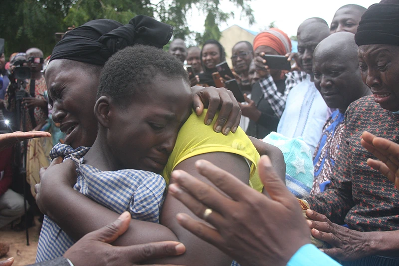 TOPSHOT-NIGERIA-UNREST-KIDNAPPING
TOPSHOT - A mother hugs her daughter on July 25, 2021 after she was released together with other 27 students of the Bethel Baptist High School. - Gunmen who seized 121 students at a high school in northwestern Nigeria in early July have released 28 of them, a school official told AFP on Sunday. The attackers stormed Bethel Baptist High School in northwestern Kaduna state on July 5, abducting students who were sleeping in their dorms. (Photo by - / AFP) (Photo by -/AFP via Getty Images)