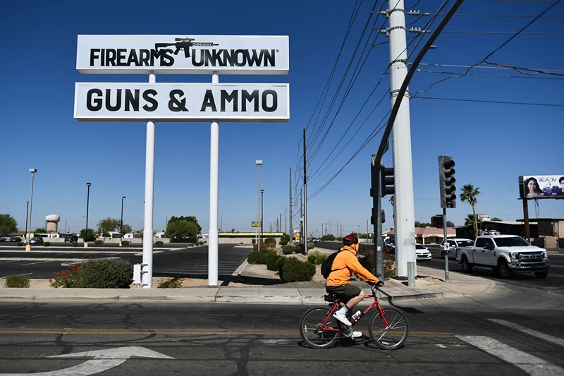 TOPSHOT-US-WEAPONRY
TOPSHOT - The silhouette AR-15 style rifle is displayed on signage for the Firearms Unknown Guns & Ammo gun store, in Yuma, Arizona on June 2, 2022. - US President Joe Biden on June 2, 2022 urged lawmakers to ban privately owned assault weapons and high capacity magazines in order to curb the mass shootings plaguing the country. (Photo by Patrick T. FALLON / AFP) (Photo by PATRICK T. FALLON/AFP via Getty Images)