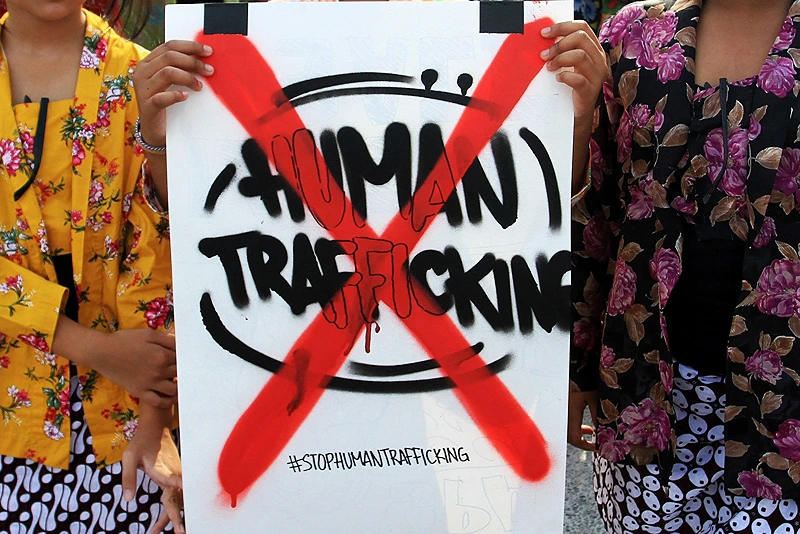 INDONESIA-CRIME-TRAFFICKING-PROTEST
Youths pose with a placard during a protest to mark the World Day against Trafficking in Persons, in Yogyakarta on July 31, 2022. (Photo by DEVI RAHMAN / AFP) (Photo by DEVI RAHMAN/AFP via Getty Images)