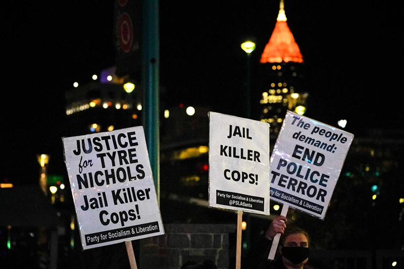 US-POLICE-JUSTICE-DEMO
Protesters holds placards as they rally against the fatal police assault of Tyre Nichols, in Atlanta, Georgia, on January 27, 2023. - The US city of Memphis released January 27, 2023 graphic video footage depicting the fatal police assault of a 29-year-old Black man, as cities nationwide braced for a night of protests against police brutality. Five Memphis officers, also all Black, were charged with second-degree murder in the beating of Tyre Nichols, who died in hospital on January 10 three days after being stopped on suspicion of reckless driving. (Photo by CHENEY ORR / AFP) (Photo by CHENEY ORR/AFP via Getty Images)