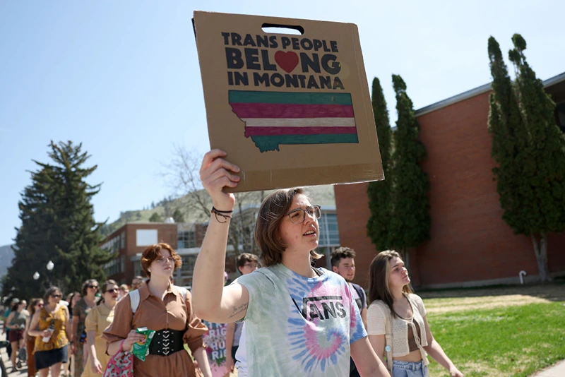 MISSOULA, MONTANA - MAY 03: Transgender rights activists hold signs as they march through the University of Montana campus on May 03, 2023 in Missoula, Montana. Dozens of students and transgender rights activists staged a demonstration on the University of Montana campus to protest the censure of transgender Montana state Rep. Zooey Zephyr by House Republicans in the Montana State Legislature for breaking House rules of decorum by saying state legislators would have 