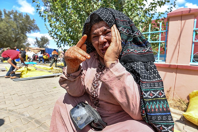 MOROCCO-QUAKE
Fatima, a 59-year-old earthquake survivor, reacts after receiving a shelter tent and relief aid in the town of Amizmiz in al-Haouz province in the High Atlas mountains of central Morocco on September 12, 2023. Hopes dimmed on September 12 in Morocco's search for survivors, four days after a powerful 6.8-magnitude earthquake killed more than 2,900 people, most of them in remote villages of the High Atlas Mountains. (Photo by FETHI BELAID / AFP) (Photo by FETHI BELAID/AFP via Getty Images)