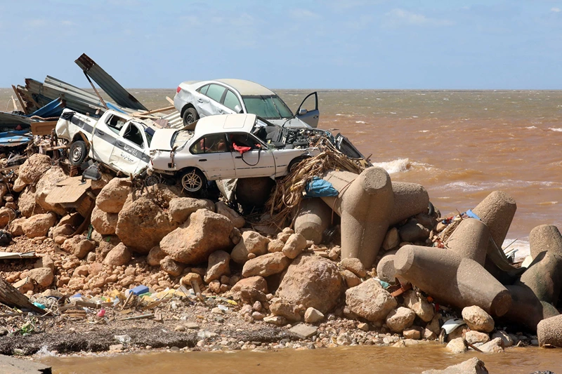 LIBYA-STORM-FLOOD
Cars are piled up atop wave breakers and the rubble of a building destroyed in flash floods after the Mediterranean storm "Daniel" hit Libya's eastern city of Derna, on September 14, 2023. A global aid effort for Libya gathered pace on September 14 after a tsunami-sized flash flood killed at least 4,000 people, with thousands more missing, a death toll the UN blamed in part on the legacy of years of war and chaos. (Photo by Abdullah DOMA / AFP) (Photo by ABDULLAH DOMA/AFP via Getty Images)