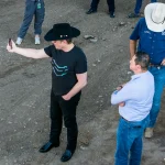 Elon Musk Visits Texas-Mexico Border EAGLE PASS, TEXAS - SEPTEMBER 28: An aerial view of tech entrepreneur Elon Musk, wearing a black Stetson hat, livestreaming while visiting the Texas-Mexico border on September 28, 2023 in Eagle Pass, Texas. Musk toured the border along the bank of the Rio Grande with Rep. Tony Gonzales (R-Texas) to see firsthand the ongoing migrant crisis, which he has called a "serious issue." (Photo by John Moore/Getty Images)