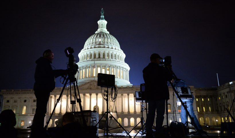 TOPSHOT - The US Capitol Building is pictured as media gather on January 20, 2017 in Washington, DC. Donald Trump will be sworn in as the 45th president of the United States Friday -- capping his improbable journey to the White House and beginning a four-year term that promises to shake up Washington and the world. / AFP / Robyn Beck (Photo credit should read ROBYN BECK/AFP via Getty Images)