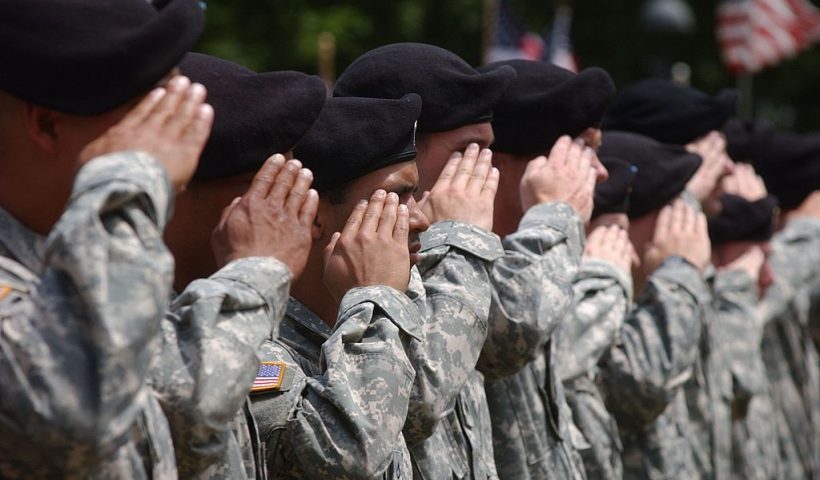 CAMBRIDGE, MA - JULY 8: Soldiers with C Company, First Battalion of the 181st Infantry Regiment of the Massachusetts National Guard stand at attention during a deployment ceremony on Cambridge Common July 8, 2007 in Cambridge, Massachusetts. The historic unit was led by Paul Revere against British forces on Lexington Green and in Concord in 1775 and also fought in World Wars I and II and also in Bosnia. This is the first deployment to Iraq for most of the soldiers in the 88 man unit. (Photo by Darren McCollester/Getty Images)