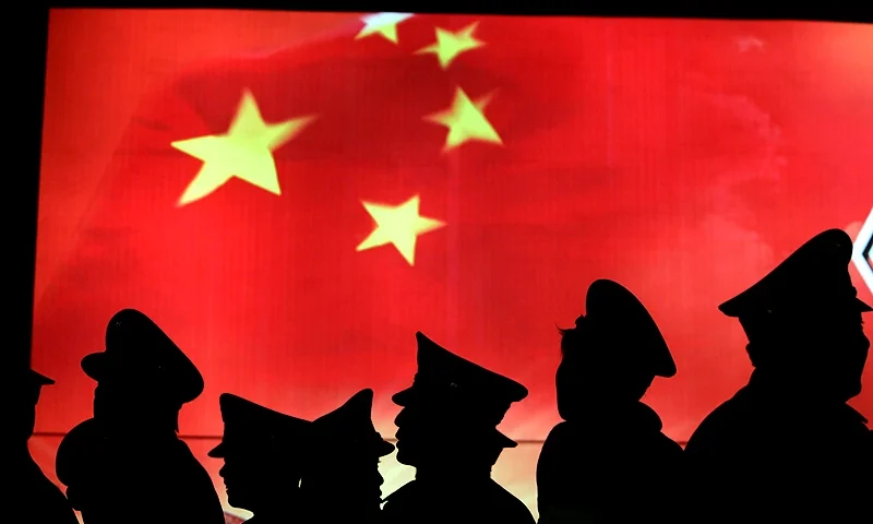 BEIJING, CHINA - MARCH 1: (CHINA OUT) Security guard walk past the Chinese national flag at the Military Museum of Chinese People's Revolution on March 1, 2008 in Beijing, China. From March 1, the Military Museum of Chinese People's Revolution becomes the first national level museum which opens to the public for free in Beijing. (Photo by China Photos/Getty Images)