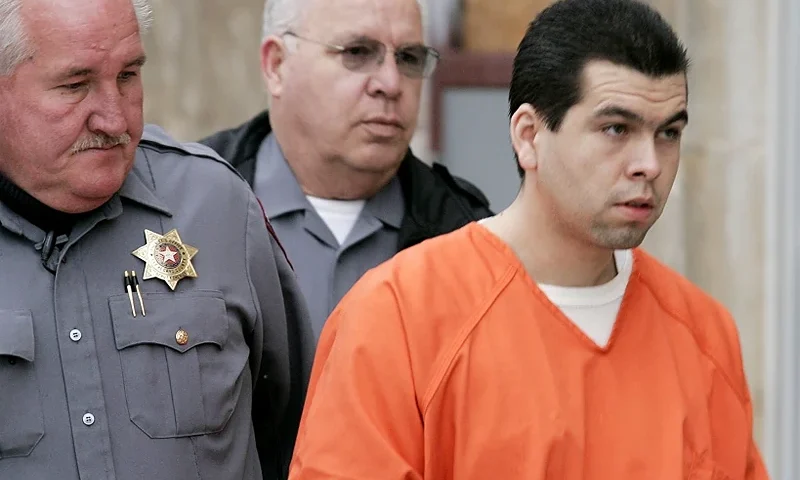 Anthony Sanchez, right, is escorted into a Cleveland County courtroom for a preliminary hearing, Feb. 23, 2005, in Norman, Okla. On Thursday, Sept. 21, 2023, Oklahoma plans to execute Sanchez for the 1996 slaying of a University of Oklahoma dance student in a case that went unsolved for years. Sanchez, 44, is scheduled to receive a lethal injection at 10 a.m. at the Oklahoma State Penitentiary in McAlester, Okla. (Jaconna Aguirre/The Oklahoman via AP, File)