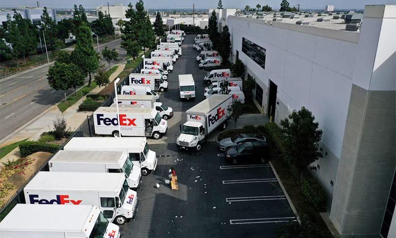 A worker clears debris so delivery vehicles can exit a FedEx Ground distribution center in this aerial photograph taken over Carson, California, U.S., September 16, 2022. REUTERS/Bing Guan/File Photo