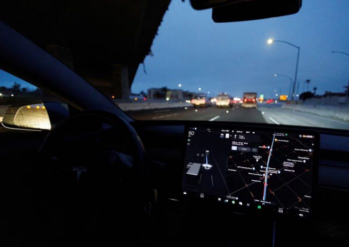 A Tesla Model 3 vehicle drives on autopilot along the 405 highway in Westminster, California, U.S., March 16, 2022. REUTERS/Mike Blake/File Photo