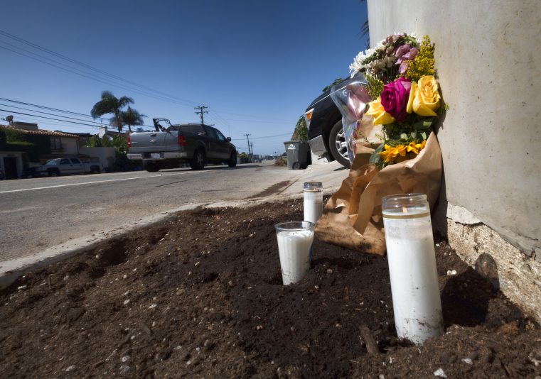 Candles and flowers are placed along along the Pacific Coast Highway, after a crash that killed four college students and injured two others, in Malibu, Calif., on Thursday, Oct. 19, 2023. Officials say police have arrested a 22-year-old driver on suspicion of manslaughter. Sheriff's officials say six pedestrians were struck at about 8:30 p.m. Tuesday along Pacific Coast Highway, a few miles east of Pepperdine University. (AP Photo/Richard Vogel)
