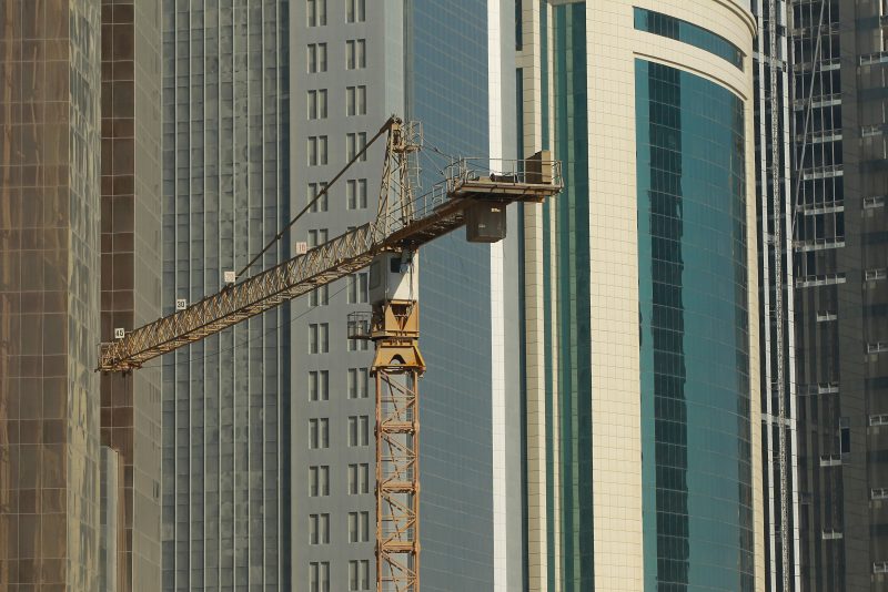 DOHA, QATAR - OCTOBER 24: A crane at a construction site stands among new highrise office buildings and hotels under construction in the new City Center and West Bay district on October 24, 2010 in Doha, Qatar. The International Monetary Fund (IMF) recently reiterated its projection for the Qatari economy with predictions of double digit growth for 2010 and 2011. Though natural gas and petroleum production are still the biggest two single sources of income, the non-energy sector overtook oil and gas in Qatari GDP for 2009. Qatar is heavily dependant on foreign labour from countries such as India, Sri Lanka, Bangladesh, the Phillipines and other Arab countries. Foreigners make up approximately two thirds of the Qatari population. (Photo by Sean Gallup/Getty Images)