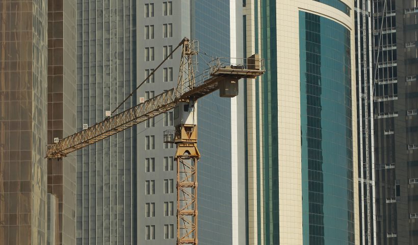 DOHA, QATAR - OCTOBER 24: A crane at a construction site stands among new highrise office buildings and hotels under construction in the new City Center and West Bay district on October 24, 2010 in Doha, Qatar. The International Monetary Fund (IMF) recently reiterated its projection for the Qatari economy with predictions of double digit growth for 2010 and 2011. Though natural gas and petroleum production are still the biggest two single sources of income, the non-energy sector overtook oil and gas in Qatari GDP for 2009. Qatar is heavily dependant on foreign labour from countries such as India, Sri Lanka, Bangladesh, the Phillipines and other Arab countries. Foreigners make up approximately two thirds of the Qatari population. (Photo by Sean Gallup/Getty Images)