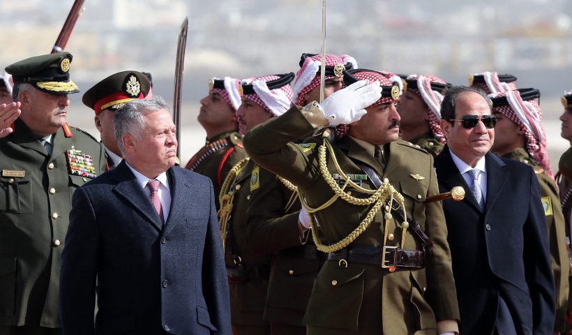 King Abdullah II of Jordan (L) and Egyptian President Abdel Fattah al-Sisi review an honour guard upon Sisi's arrival at Marka International Aiport, in the Jordanian capital Amman on January 13, 2018. (Photo by Khalil MAZRAAWI / AFP) (Photo credit should read KHALIL MAZRAAWI/AFP via Getty Images)