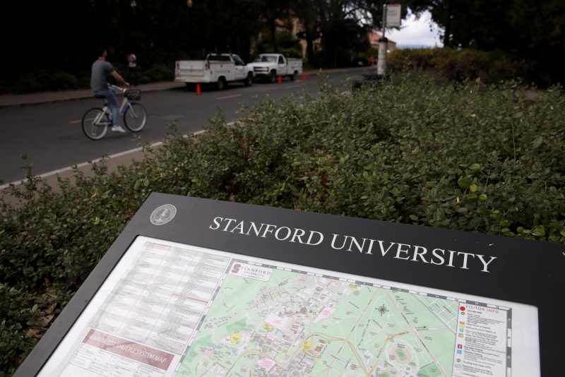 More Than 30 People Charged In Elite College Entry Bribery Scheme STANFORD, - MARCH 12: A cyclist rides by a map of the Stanford University campus on March 12, 2019 in Stanford, California. More than 40 people, including actresses Lori Loughlin and Felicity Huffman, have been charged in a widespread elite college admission bribery scheme. Parents, ACT and SAT administrators and coaches at universities including Stanford, Georgetown, Yale, and the University of Southern California have been charged. (Photo by Justin Sullivan/Getty Images)