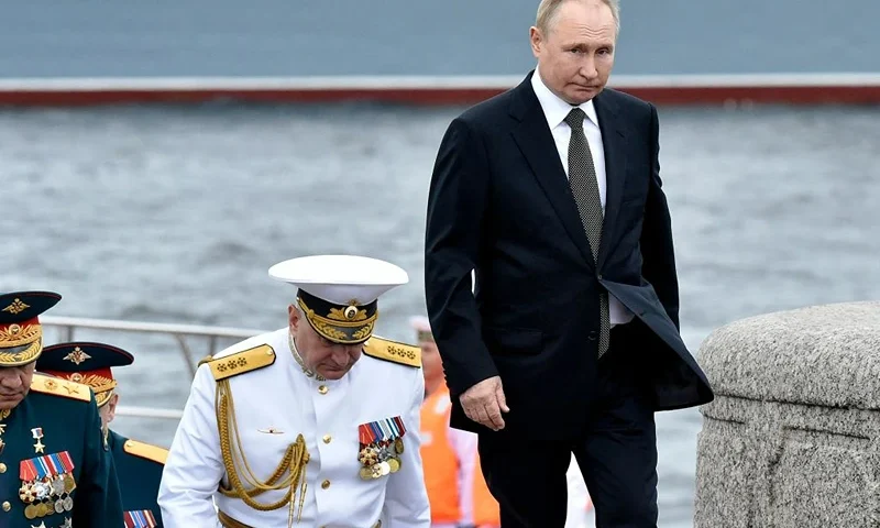 Russia's President Vladimir Putin (R) walks with Commander-in-Chief of the Russian Navy, Admiral Nikolai Yevmenov (C) as he takes part in the main naval parade marking Russian Navy Day, in St. Petersburg on July 31, 2022. (Photo by Olga MALTSEVA / AFP) (Photo by OLGA MALTSEVA/AFP via Getty Images)