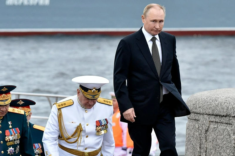 Russia's President Vladimir Putin (R) walks with Commander-in-Chief of the Russian Navy, Admiral Nikolai Yevmenov (C) as he takes part in the main naval parade marking Russian Navy Day, in St. Petersburg on July 31, 2022. (Photo by Olga MALTSEVA / AFP) (Photo by OLGA MALTSEVA/AFP via Getty Images)