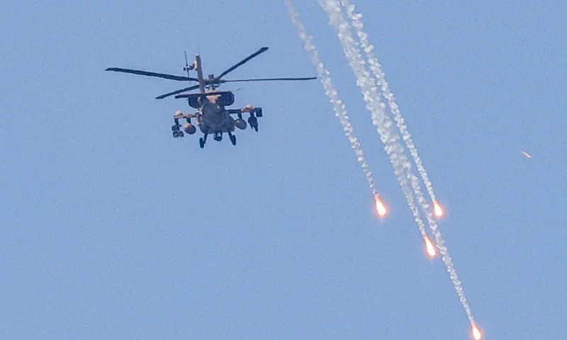 TOPSHOT - An Israeli military AH-64 Apache attack helicopter fires flares while flying over Ashkelon in southern Israel on August 6, 2022. - Israel hit Gaza with air strikes and the Palestinian Islamic Jihad militant group retaliated with a barrage of rocket fire, in the territory's worst escalation of violence since a war last year. Israel has said it was forced to launch a "pre-emptive" operation against Islamic Jihad, insisting the group was planning an imminent attack following days of tensions along the Gaza border. (Photo by Jack Guez / AFP) (Photo by JACK GUEZ/AFP via Getty Images)