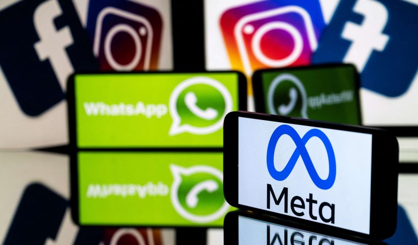 This picture taken on January 12, 2023 in Toulouse, southwestern France shows a smartphone and a computer screen displaying the logos of the Instagram, Facebook, WhatsApp and their parent company Meta. (Photo by Lionel BONAVENTURE / AFP) (Photo by LIONEL BONAVENTURE/AFP via Getty Images)