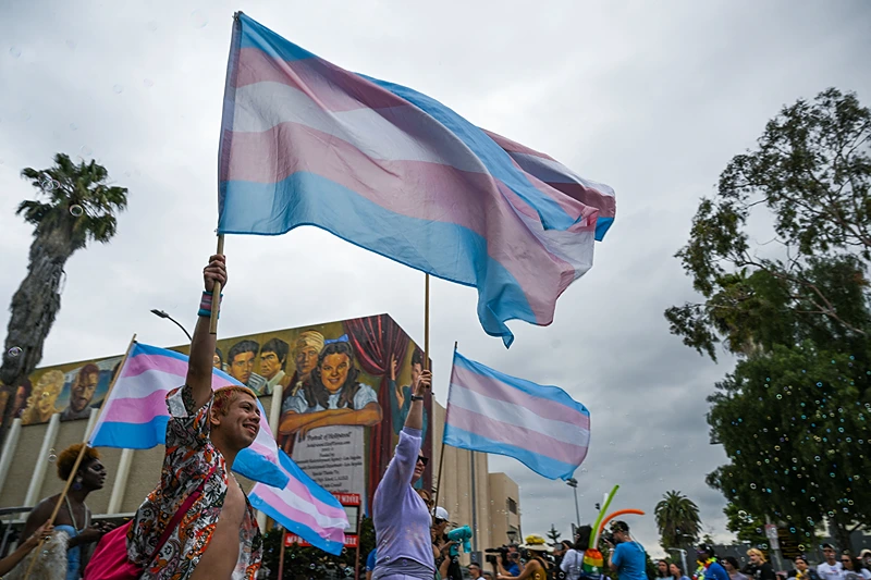 US-LGBTQ-PRIDE-PARADE
People wave a Transgender Pride flag as they attend the 2023 LA Pride Parade on June 11, 2023 in Hollywood, California. The LA Pride Parade marks the last day of the three-day Los Angeles celebration of lesbian, gay, bisexual, transgender, and queer (LGBTQ) social and self-acceptance, achievements, legal rights, and pride. (Photo by Robyn Beck / AFP) (Photo by ROBYN BECK/AFP via Getty Images)