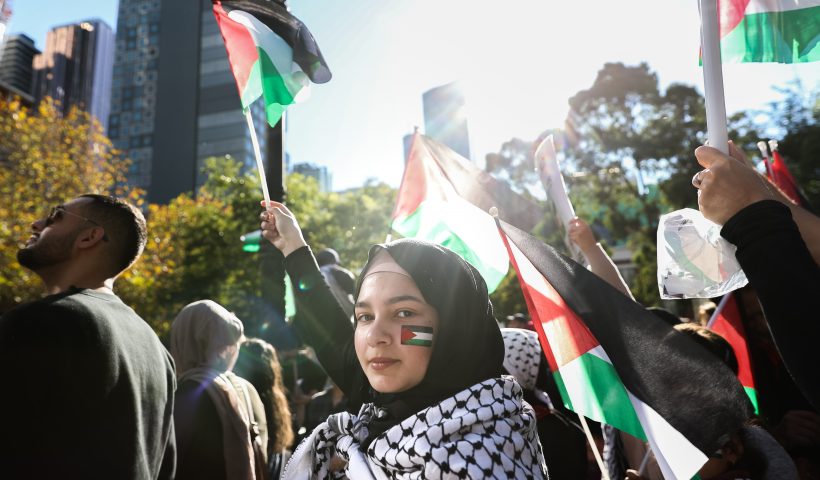 MELBOURNE, AUSTRALIA - MAY 22: A Pro-Palestinian protestor with the Palestinian flag painted on her face is seen waving a Palestinian flag during a Rally on May 22, 2021 in Melbourne, Australia. Rallies were organised across Australia to protest against the recent violence in Israel and the Gaza strip. A ceasefire between Israel and Hamas in Gaza started on Friday, following 11 days of rocket attacks. (Photo by Asanka Ratnayake/Getty Images)