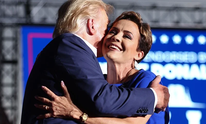 Donald Trump Holds Campaign Rally In Support Of Arizona GOP Candidates MESA, ARIZONA - OCTOBER 09: Former U.S. President Donald Trump embraces Arizona Republican gubernatorial nominee Kari Lake at a campaign rally at Legacy Sports USA on October 09, 2022 in Mesa, Arizona. Trump was stumping for Arizona GOP candidates ahead of the midterm election on November 8. (Photo by Mario Tama/Getty Images)