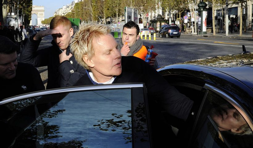 US Mike Jeffries, CEO of US clothing retailer Abercrombie & Fitch leaves the store on the Champs Elysees avenue in Paris on October 27, 2012, as some workers protest against their working conditions. They declared the management did not respect French social rules. AFP PHOTO BERTRAND GUAY (Photo credit should read BERTRAND GUAY/AFP via Getty Images)
