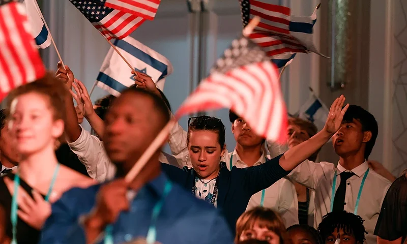 ARLINGTON, VIRGINIA - JULY 17: Attendees wave Israel and the United States flags at the Christians United for Israel (CUFI) summit on July 17, 2023 in Arlington, Virginia. GOP presidential hopefuls for 2024 are making their cases before the pro-Israeli group. (Photo by Anna Moneymaker/Getty Images)
