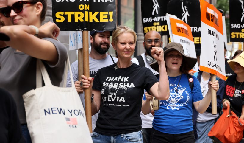 NEW YORK, NEW YORK - JULY 21: Cynthia Nixon (C) joins SAG-AFTRA members on the picket line outside of Netflix and Warner Bros on July 21, 2023 in New York City. Members of SAG-AFTRA, Hollywood's largest union which represents actors and other media professionals, have joined striking WGA (Writers Guild of America) workers in the first joint walkout against the studios since 1960. The strike could shut down Hollywood productions completely with writers in the third month of their strike against the Hollywood studios. (Photo by Dia Dipasupil/Getty Images)
