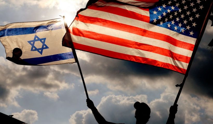 TOPSHOT - A protester waves US and Israeli national flags during a demonstration in front of the US embassy in Tel Aviv, as Israel's Prime Minister Benjamin Netanyahu is in New York to meet President Joe Biden, on September 20, 2023. US President Joe Biden and Prime Minister Benjamin Netanyahu tried to smooth over months of tensions as they met for the first time on September 20, since the Israeli's reelection in December. (Photo by JACK GUEZ / AFP) (Photo by JACK GUEZ/AFP via Getty Images)