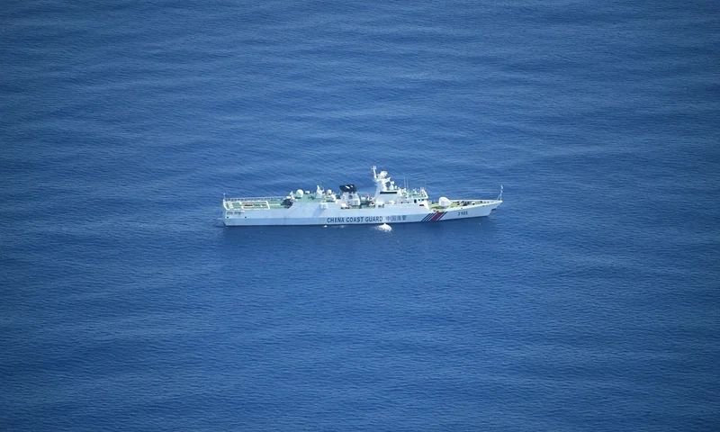 This photo taken on September 28, 2023 shows an aerial view of a Chinese coast guard ship on patrol near the Chinese-controlled Scarborough Shoal during a maritime surveillance flight by the Philippine Bureau of Fisheries and Aquatic Resources (BFAR) over disputed waters of the South China Sea. The Philippine Coast Guard vowed September 29 to "do whatever it takes" to remove any more floating barriers installed by China at a disputed reef in the South China Sea. The remarks came after an aerial inspection of Scarborough Shoal on September 28 confirmed a 300 metre barrier that ignited the latest diplomatic row between Beijing and Manila had been taken away. (Photo by Ted ALJIBE / AFP) (Photo by TED ALJIBE/AFP via Getty Images)