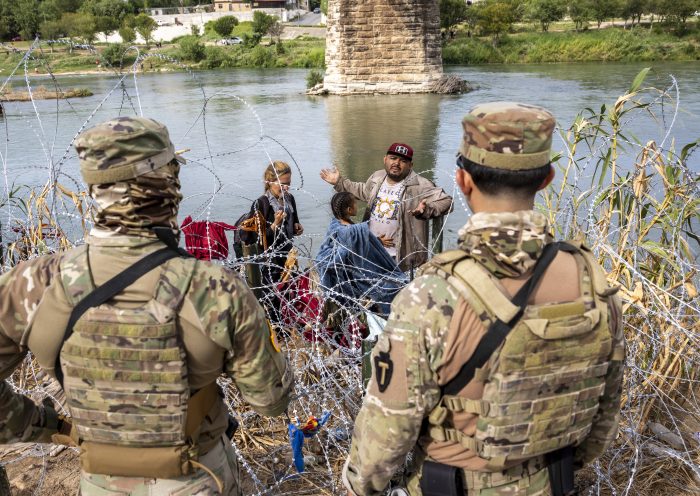 Surge In Migration Overwhelms Texas Border City Of Eagle Pass EAGLE PASS, TEXAS - SEPTEMBER 27: Venezuelan immigrant Louis Sanchez asks Texas National Guard troops to let his family pass through razor wire after they crossed the Rio Grande from Mexico on September 27, 2023 in Eagle Pass, Texas. A surge of migrants crossing the U.S. southern border seeking asylum has put pressure on U.S. immigration authorities, reaching record levels during the last week. (Photo by John Moore/Getty Images)