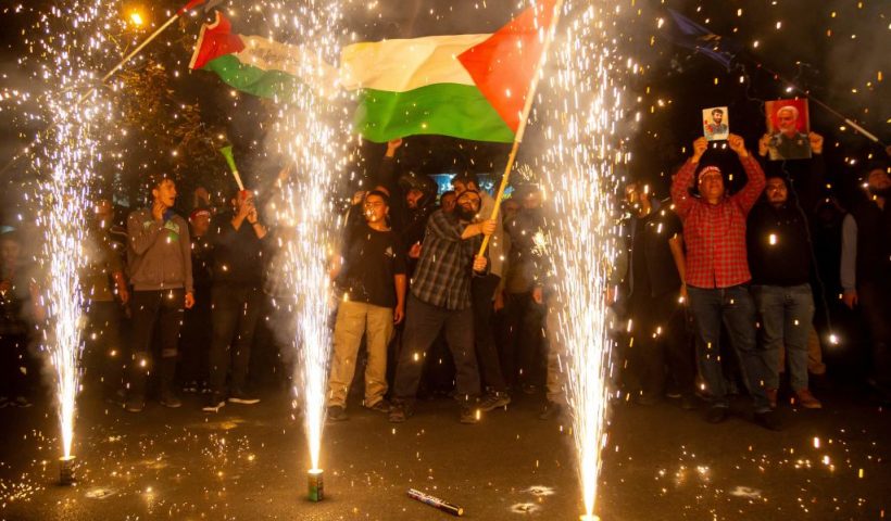 10/07/2023 Tehran, Iran. Iranian pro-government supporters celebrate the Hamas attack on Israel with fireworks and by waving a Palestinian flag in Palestine Square in Tehran.