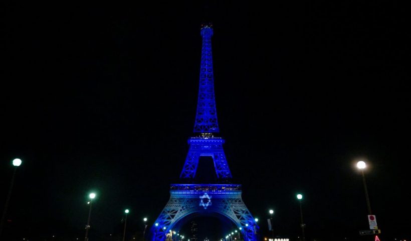 This photograph taken on October 9, 2023 shows the Eiffel Tower illuminated with the Star of David and the colours of national flag of Israel, in tribute to the victims of the recent Hamas attacks. (Photo by JULIEN DE ROSA / AFP) / RESTRICTED TO EDITORIAL USE - MANDATORY MENTION OF THE ARTIST UPON PUBLICATION - TO ILLUSTRATE THE EVENT AS SPECIFIED IN THE CAPTION (Photo by JULIEN DE ROSA/AFP via Getty Images)