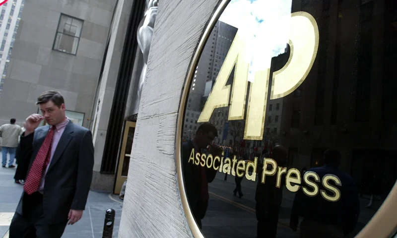 NEW YORK - JANUARY 9: A man walks out of Associated Press (AP) headquarters January 9, 2003 in New York City. Because of a contract dispute about 1,700 reporters, photographers and other editorial workers at the Associated Press will withhold their bylines today. (Photo by Mario Tama/Getty Images)