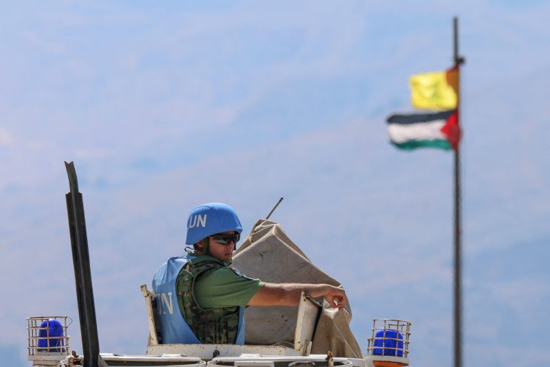 LEBANON-ISRAEL-PALESTINIAN-UN-CONFLICT
The Palestinian flag and the flag of Hezbollah wave in the wind on a pole as peacekeepers from the United Nations Interim Force in Lebanon (UNIFIL) patrol the border area between Lebanon and Israel on Hamames hill in the Khiyam area of southern Lebanon, on October 13, 2023. Israel shelled a border region in southern Lebanon, two Lebanese security sources said, after a blast occurred on the border fence, according to the Israeli army. (Photo by Joseph EID / AFP) (Photo by JOSEPH EID/AFP via Getty Images)