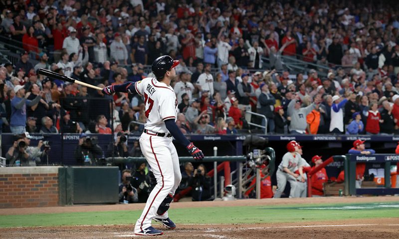 Austin Riley #27 of the Atlanta Braves hits a two-run home run in the eighth inning against the Philadelphia Phillies during Game Two of the Division Series at Truist Park on October 09, 2023 in Atlanta, Georgia. (Photo by Elsa/Getty Images)