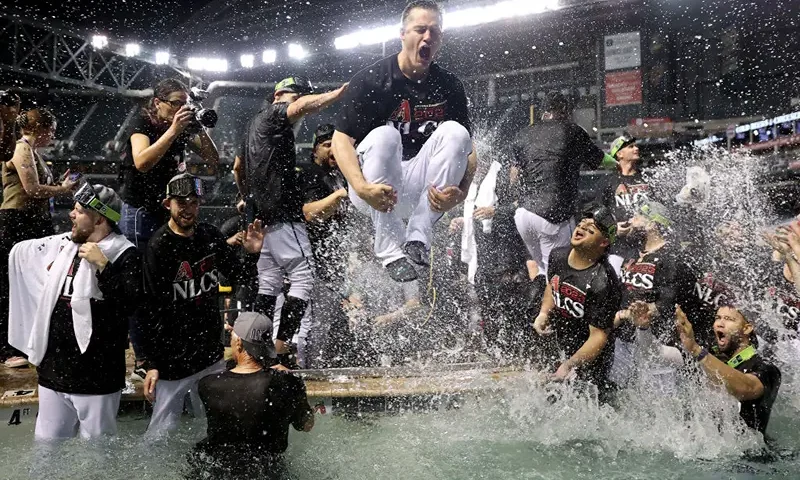 The Arizona Diamondbacks celebrate in the pool after beating the Los Angeles Dodgers 4-2 in Game Three of the Division Series at Chase Field on October 11, 2023 in Phoenix, Arizona. (Photo by Elsa/Getty Images)