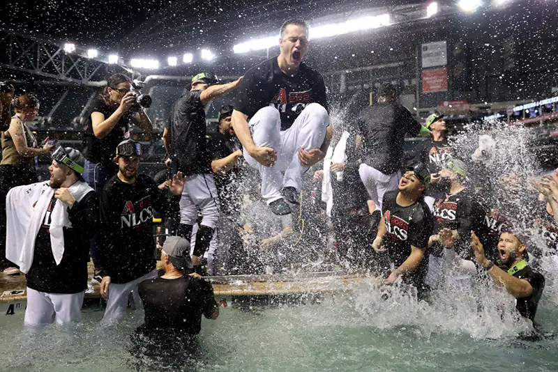 The Arizona Diamondbacks celebrate in the pool after beating the Los Angeles Dodgers 4-2 in Game Three of the Division Series at Chase Field on October 11, 2023 in Phoenix, Arizona. (Photo by Elsa/Getty Images)