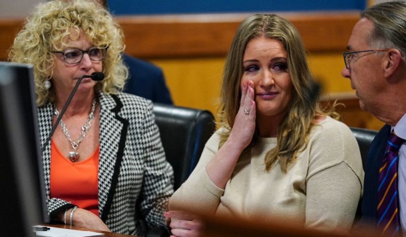 TOPSHOT - Jenna Ellis reacts with her lawyers after reading a statement pleading guilty to one felony count of aiding and abetting false statements and writings inside Fulton Superior Court Judge Scott McAfee's Fulton County Courtroom in Atlanta, Georgia, on October 24, 2023. Ellis, an attorney and prominent conservative media figure, reached a deal with prosecutors on Tuesday and pleaded guilty to a reduced charge over efforts to overturn Donald Trump's 2020 election loss in Georgia. (Photo by John Bazemore / POOL / AFP) (Photo by JOHN BAZEMORE/POOL/AFP via Getty Images)