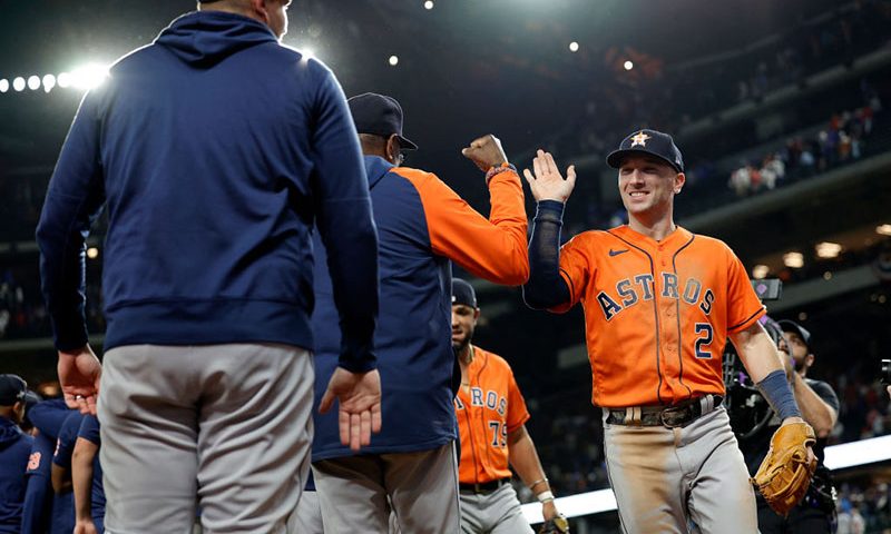 Alex Bregman #2 of the Houston Astros celebrates with teammates after beating the Texas Rangers 10-3 in Game Four of the Championship Series at Globe Life Field on October 19, 2023 in Arlington, Texas. (Photo by Carmen Mandato/Getty Images)