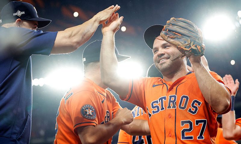 Jose Altuve #27 of the Houston Astros celebrates with his teammates after defeating the Texas Rangers in Game Five of the American League Championship Series at Globe Life Field on October 20, 2023 in Arlington, Texas. (Photo by Carmen Mandato/Getty Images)