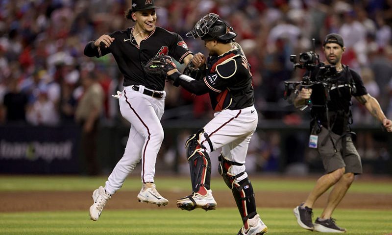PHOENIX, ARIZONA - OCTOBER 20: Alek Thomas #5 and Gabriel Moreno #14 of the Arizona Diamondbacks celebrate the victory against the Philadelphia Phillies during Game Four of the National League Championship Series at Chase Field on October 20, 2023 in Phoenix, Arizona. (Photo by Harry How/Getty Images)