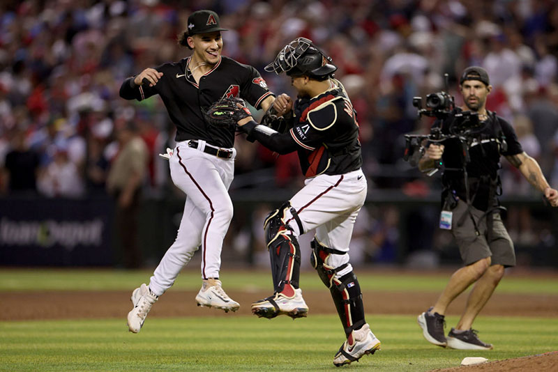 PHOENIX, ARIZONA - OCTOBER 20: Alek Thomas #5 and Gabriel Moreno #14 of the Arizona Diamondbacks celebrate the victory against the Philadelphia Phillies during Game Four of the National League Championship Series at Chase Field on October 20, 2023 in Phoenix, Arizona. (Photo by Harry How/Getty Images)