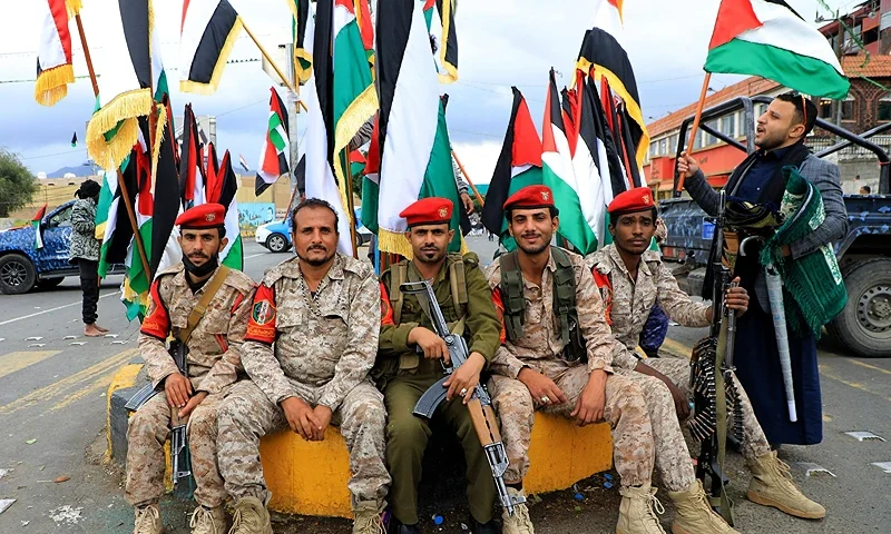 Members of Huthi-affiliated security forces pose for a photograph as they watch thousands of Yemeni Muslim worshippers take part in Friday Noon prayers in solidarity with the Palestinians of the Gaza Strip and the West Bank, in the Houthi-controlled Yemeni capital Sanaa on October 27, 2023, amid the ongoing battles between Israel and the Palestinian group Hamas in the Gaza Strip. (Photo by MOHAMMED HUWAIS / AFP) (Photo by MOHAMMED HUWAIS/AFP via Getty Images)