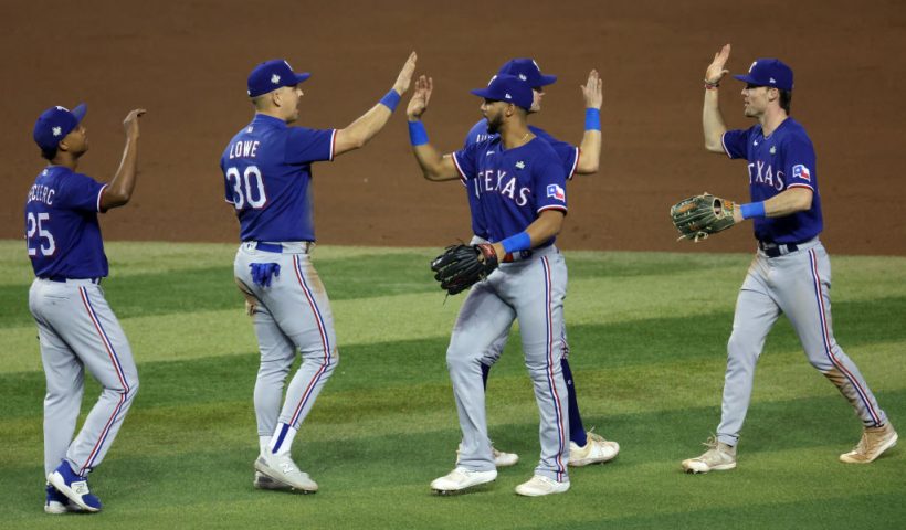 PHOENIX, ARIZONA - OCTOBER 30: The Texas Rangers celebrate after beating the Arizona Diamondbacks 3-1 in Game Three of the World Series at Chase Field on October 30, 2023 in Phoenix, Arizona. (Photo by Jamie Squire/Getty Images)